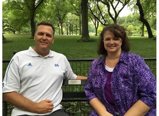 Brent Woodall’s siblings, Craig and Erin, sit on the bench they adopted in their brother’s memory. Photo courtesy of Erin Konstantinow.