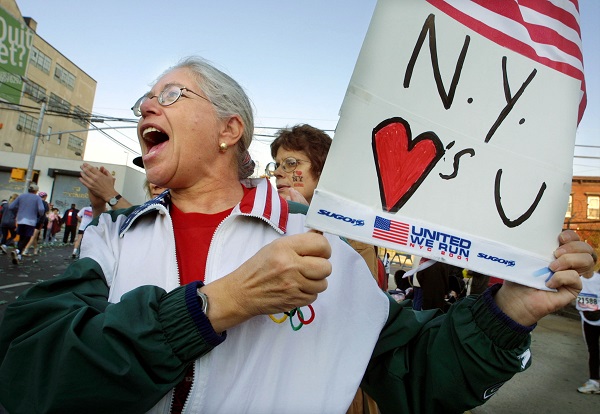 As marathon runners made their way through the borough of Queens, Roslyn Katz held up a sign of support. Photograph by Mario Tama, Getty Images.