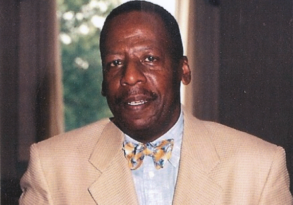 Leonard Anthony White, a technician with Verizon, wears a sport jacket and bow tie as he smiles for a portrait photo. White worked on the 110th floor of the South Tower.