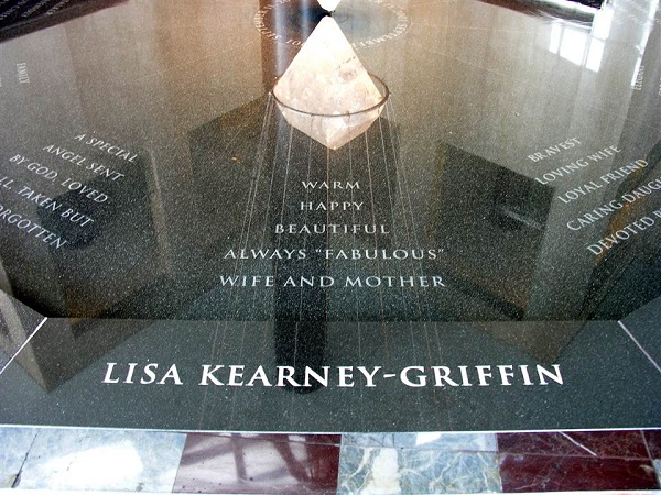 The “Eleven Tears” memorial is seen inside the ground lobby of Three World Financial Center. It includes a pool with the names of the victims and descriptions about them etched in black granite. A 600-pound quartz crystal that emits light is suspended over the pool. The name of Lisa Kearney-Griffin is in the foreground. She is described as a “warm, happy, beautiful, and always fabulous” wife and mother.