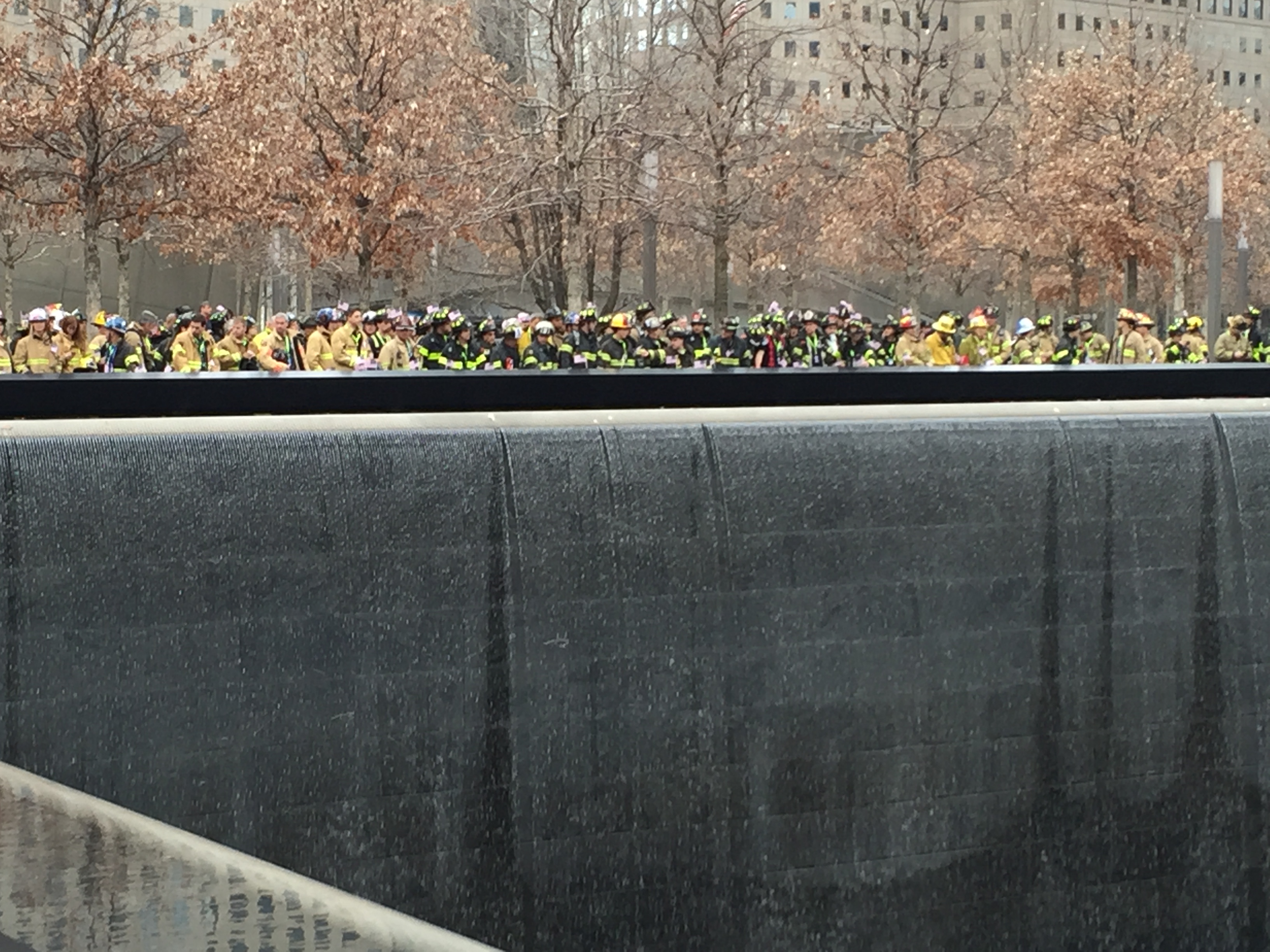 Dozens of participants taking part in the New York City firefighter stair climb pause for a moment of silence at the 9/11 Memorial.