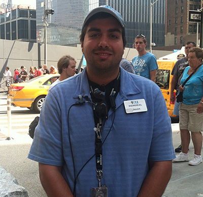 Volunteer Jason Nolan smiles outside the entrance to the Memorial.