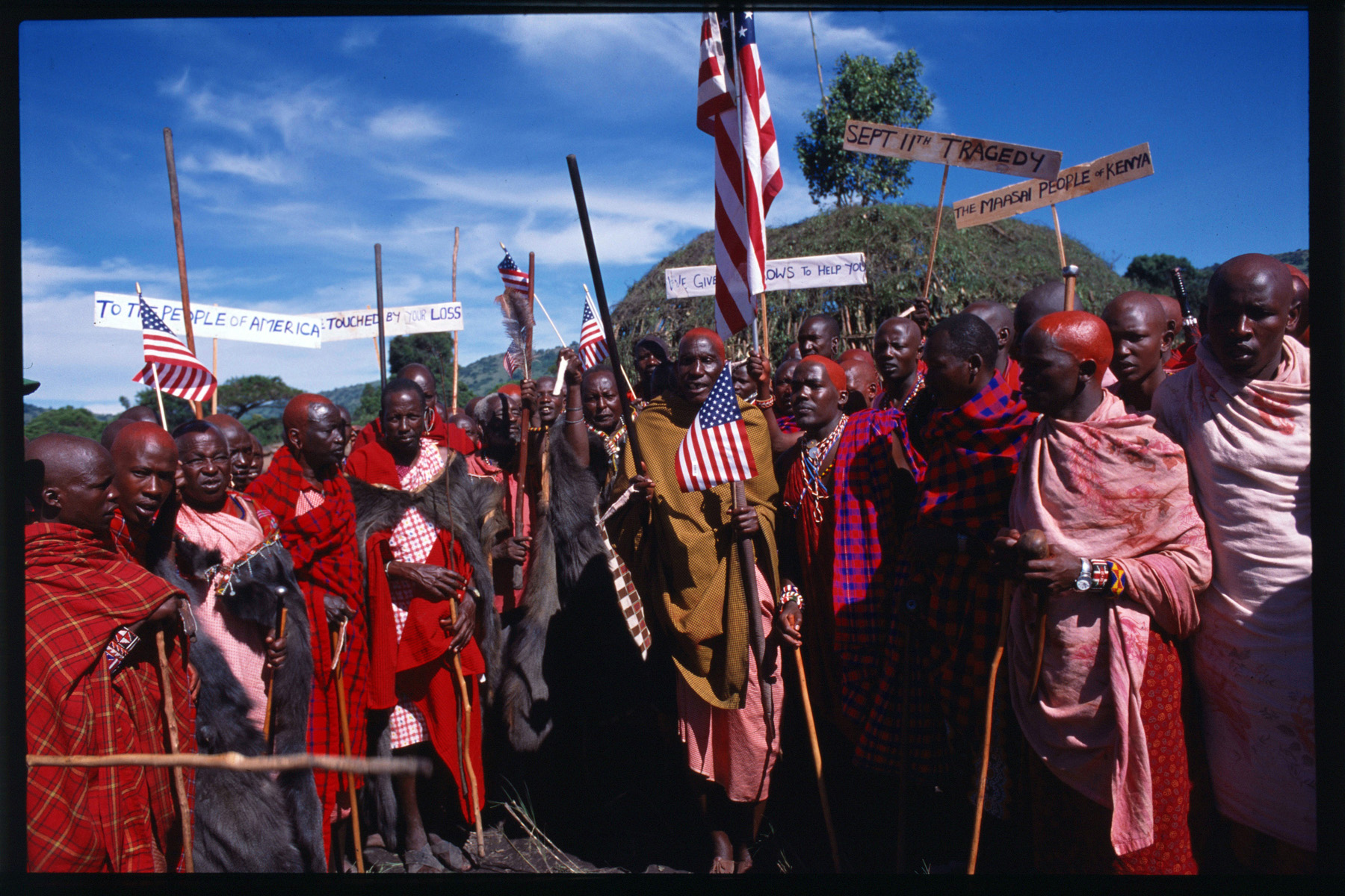 A group of Maasi carry American flags and signs showing their support after the attacks.