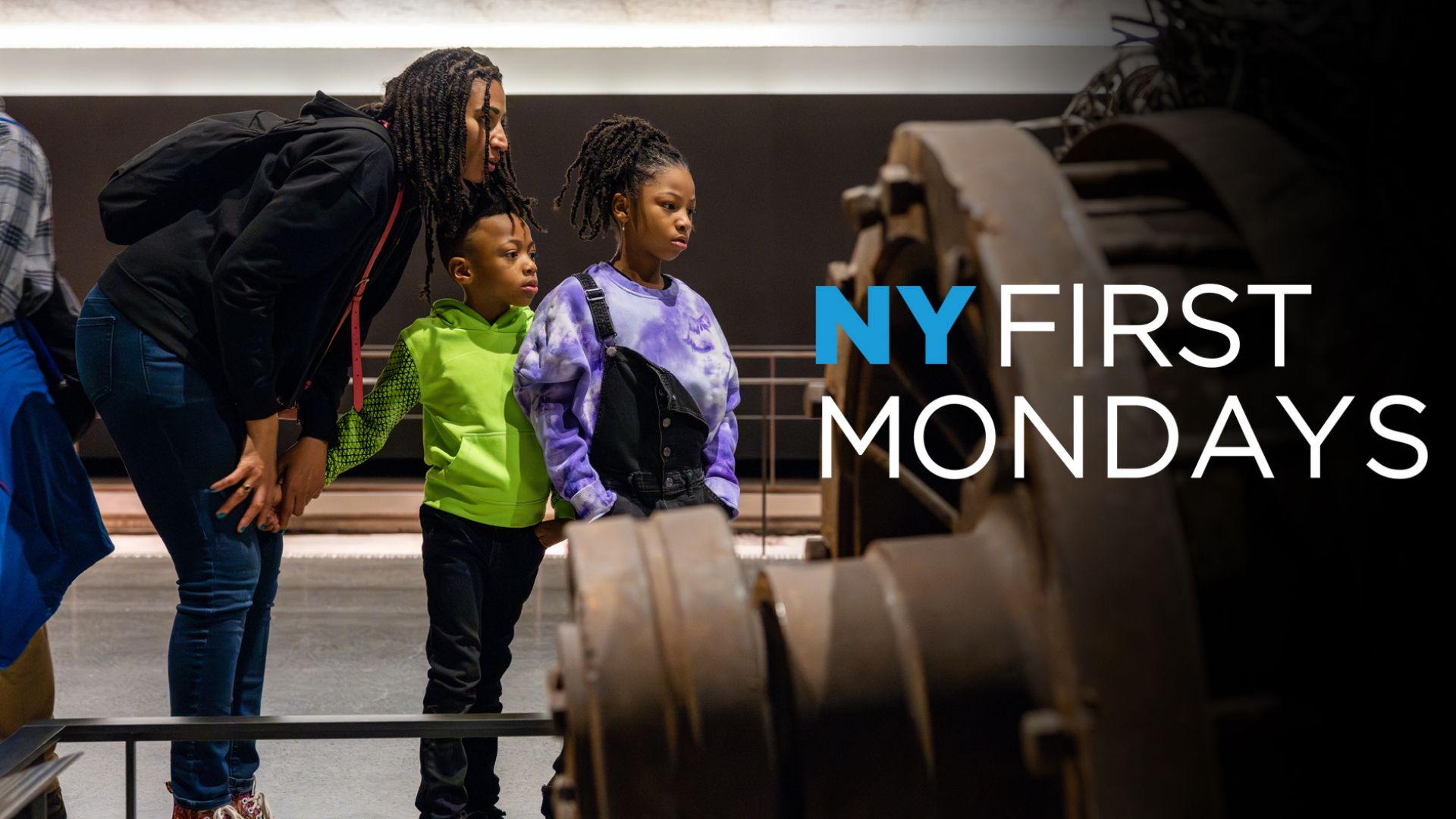 An adult and two children look at a large artifact in the Museum