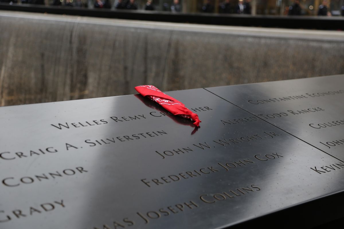 a red bandana is folded over the name WELLES REMY CROWTHER on the 9/11 Memorial pool