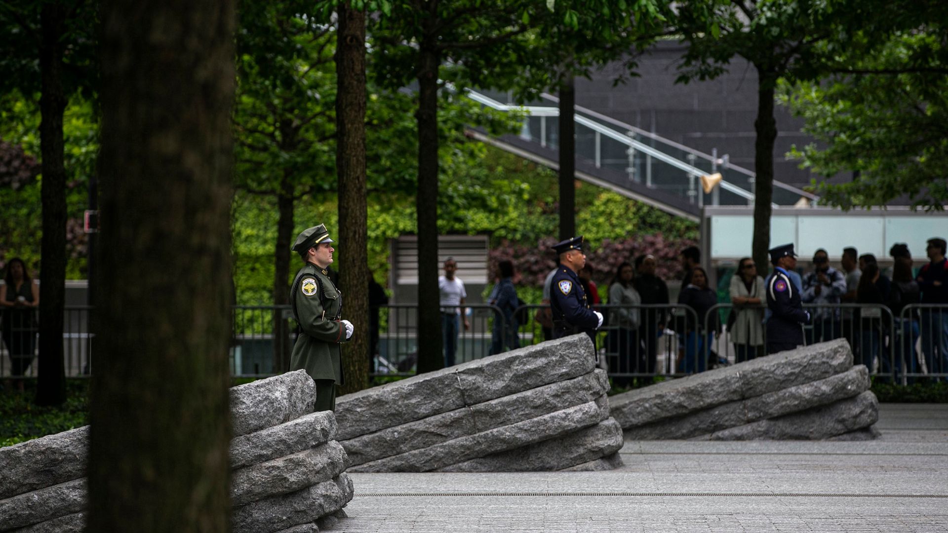 The Memorial Glade, with uniformed individuals standing between the monoliths