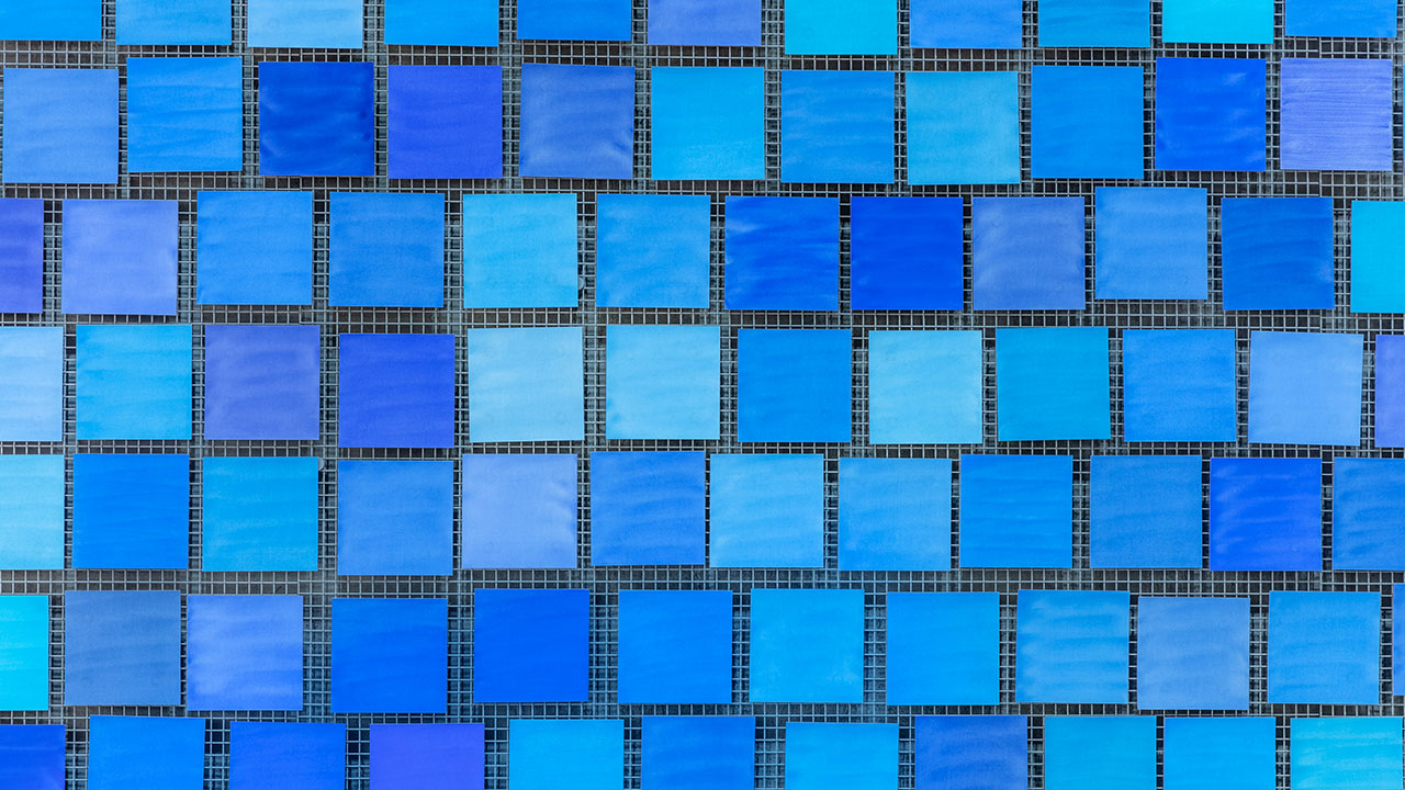 Dozens of square tiles that are varying shades of blue are seen up close in Memorial Hall.