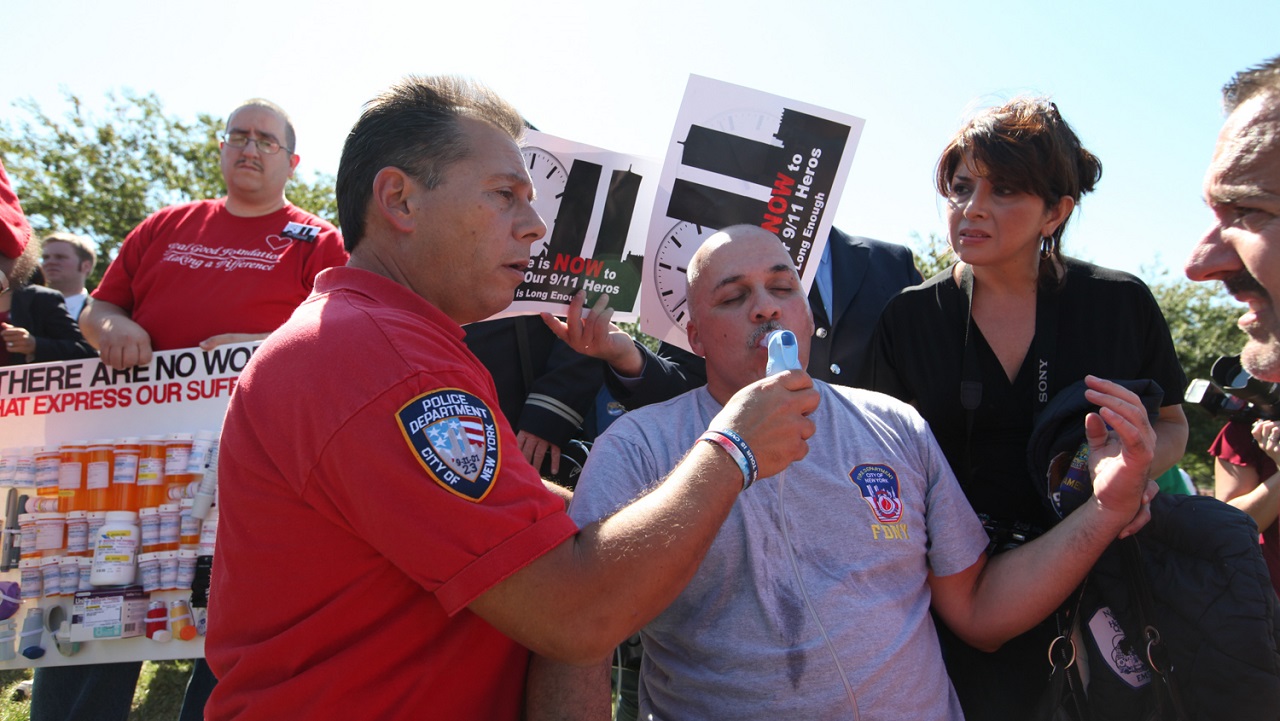 A man is treated with an inhaler for an asthma attack, at a rally for the Zadroga Act at the U.S. Capitol.