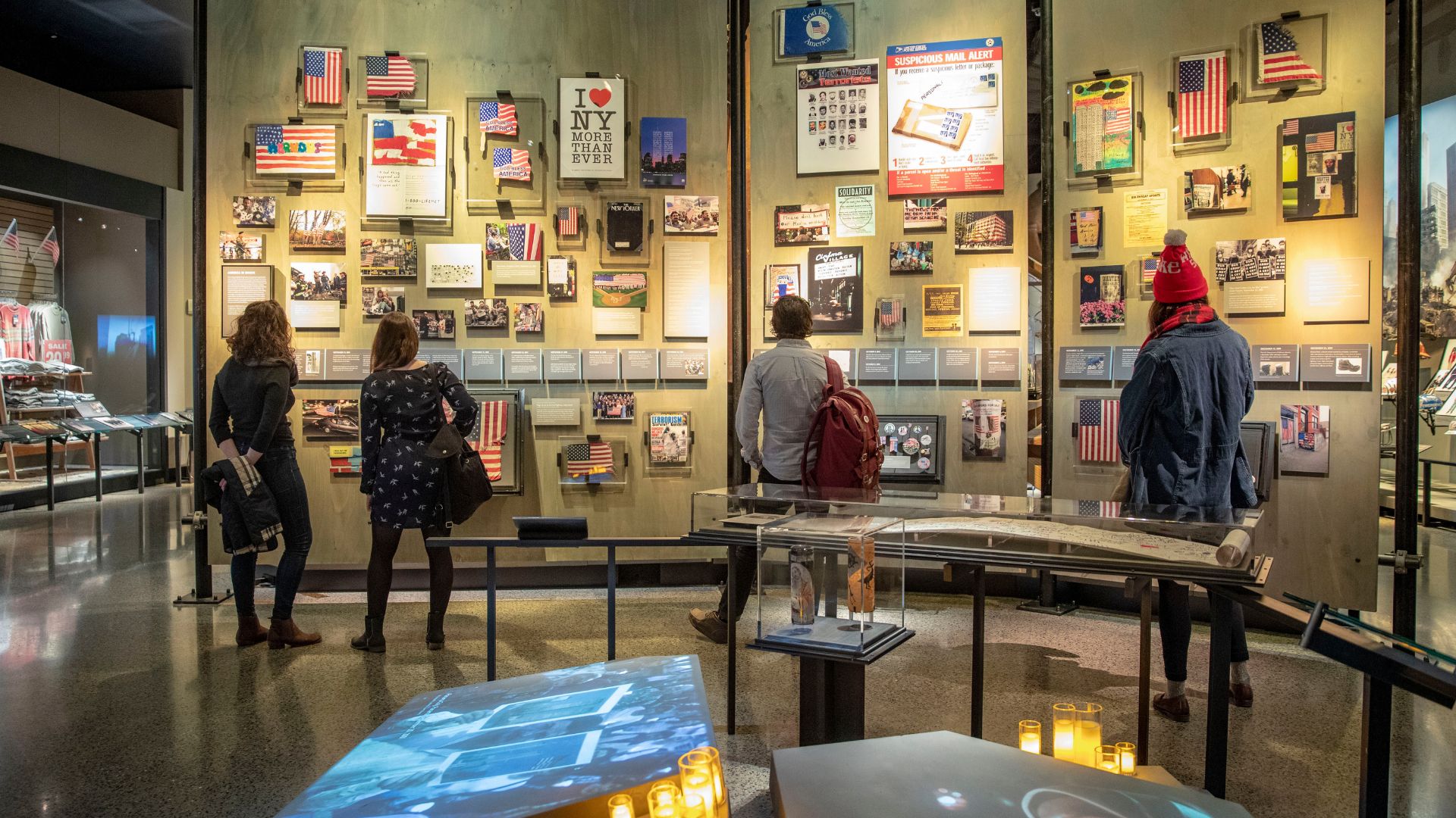 Back view of Museum visitors looking at artifacts in gallery