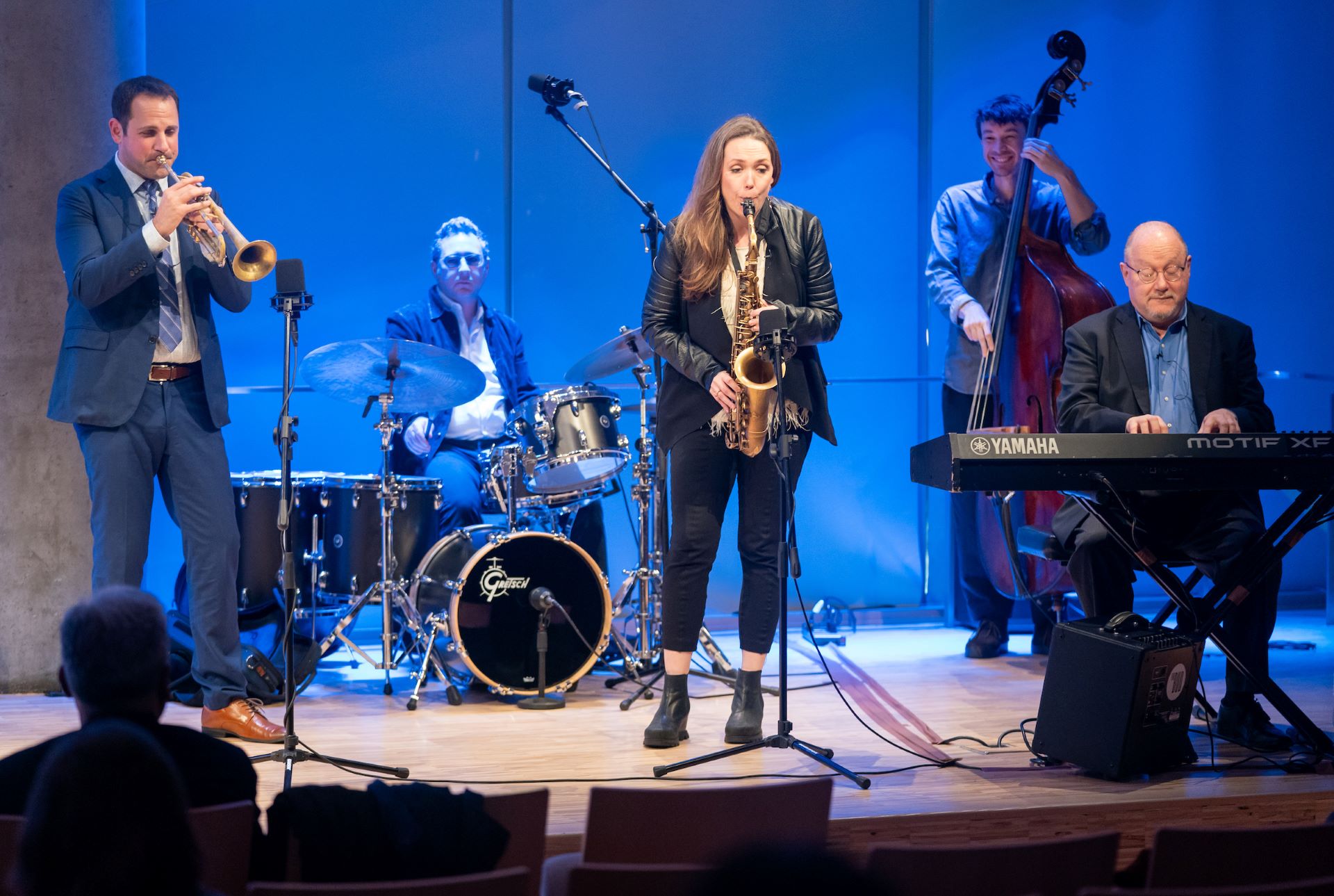 Panelists play instruments on stage 