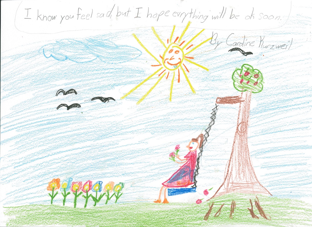 A child’s drawing depicts a girl on a tree swing. The girl is holding flowers she’s picked. More flowers are coming out of the ground. Several birds are flying by a sun with a smiling face. A message written at the top reads: “I know you feel sad, but I hope everything will be OK soon.”