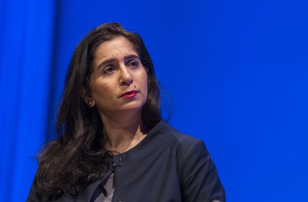 In this close-cropped photograph, a woman holds a pensive expression on her face.