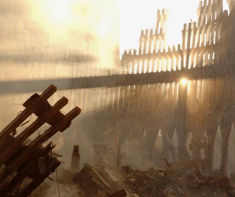 The pile at Ground Zero, against a dusty sky with sunlight peeking through in upper right corner