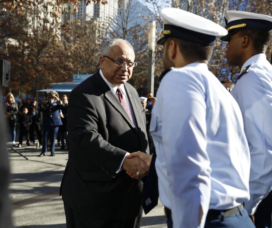 Secretary of the Navy Carlos Del Toro greets military members on the Plaza