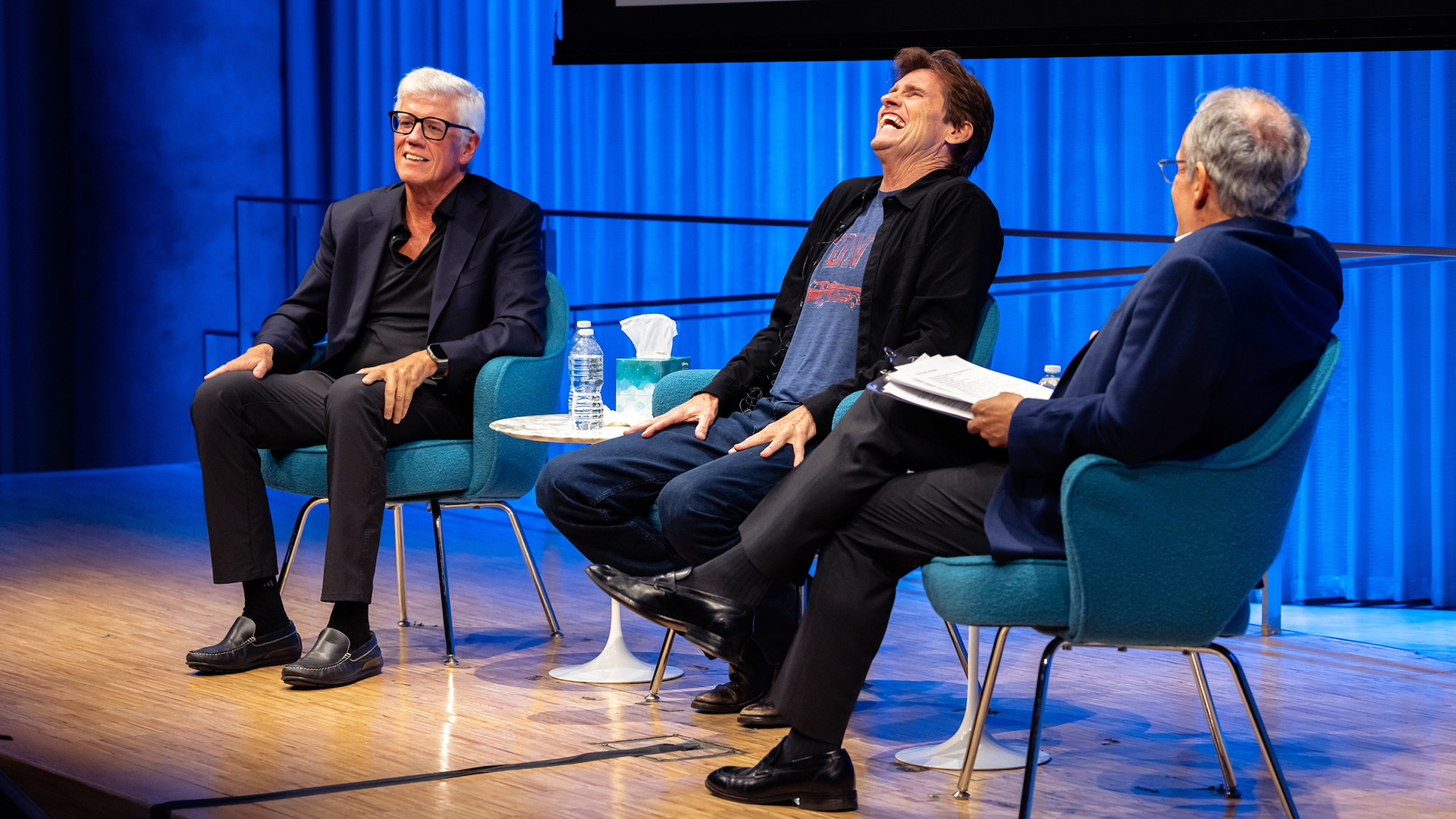 Peter Tolan (left) sitting on stage with Dennis Leary (center) and Museum Director Clifford Chanin (right)