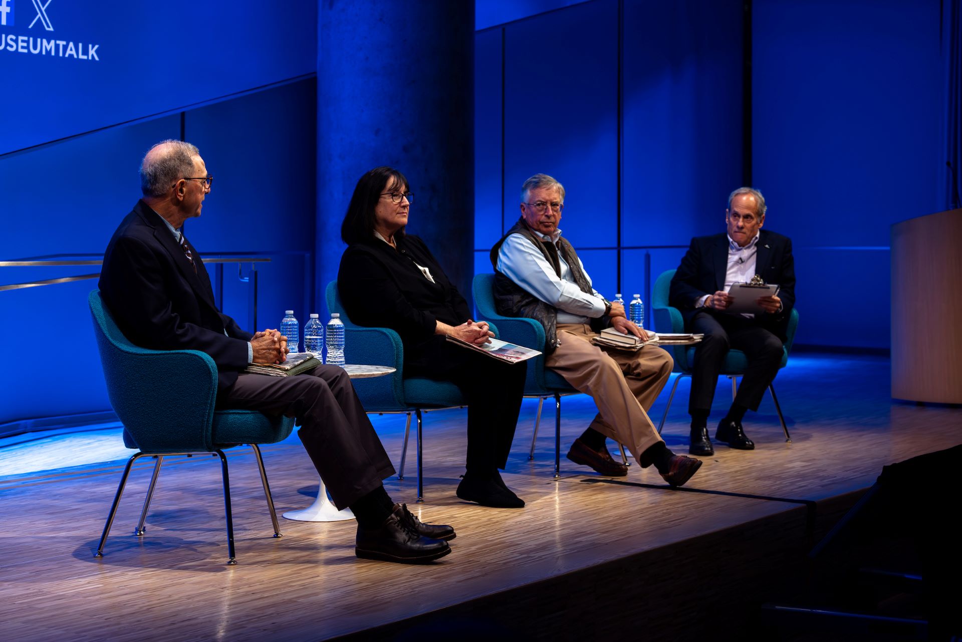 speakers and moderator on stage