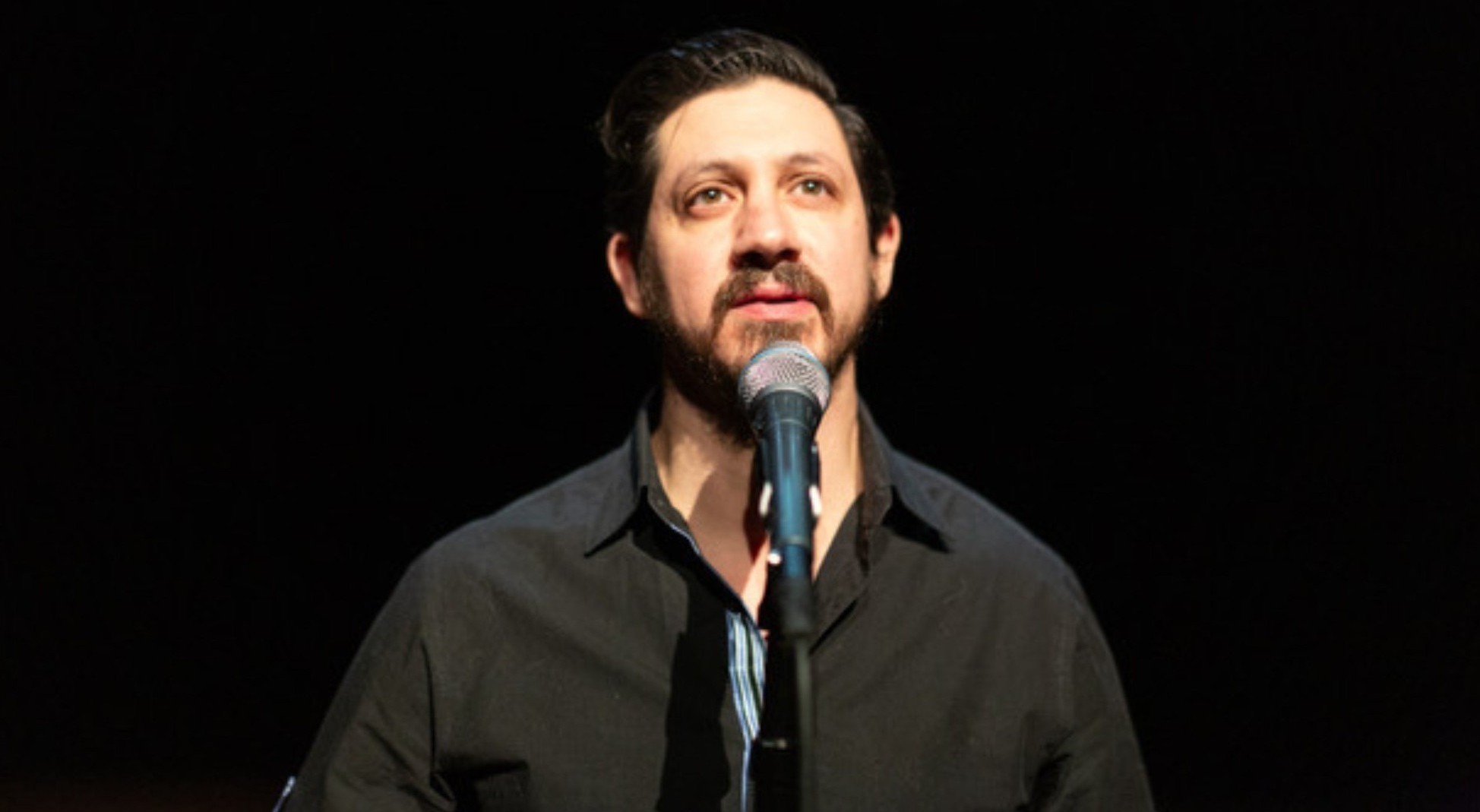 Diego Aguirre speaking into a mic