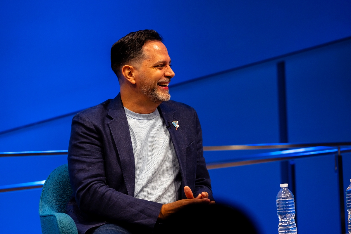 Man sits smiling and listening