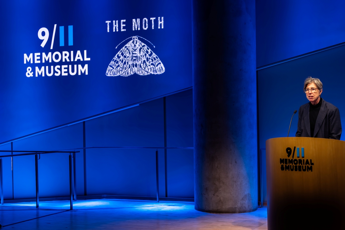 Beth Hillman introduces the program from behind a podium