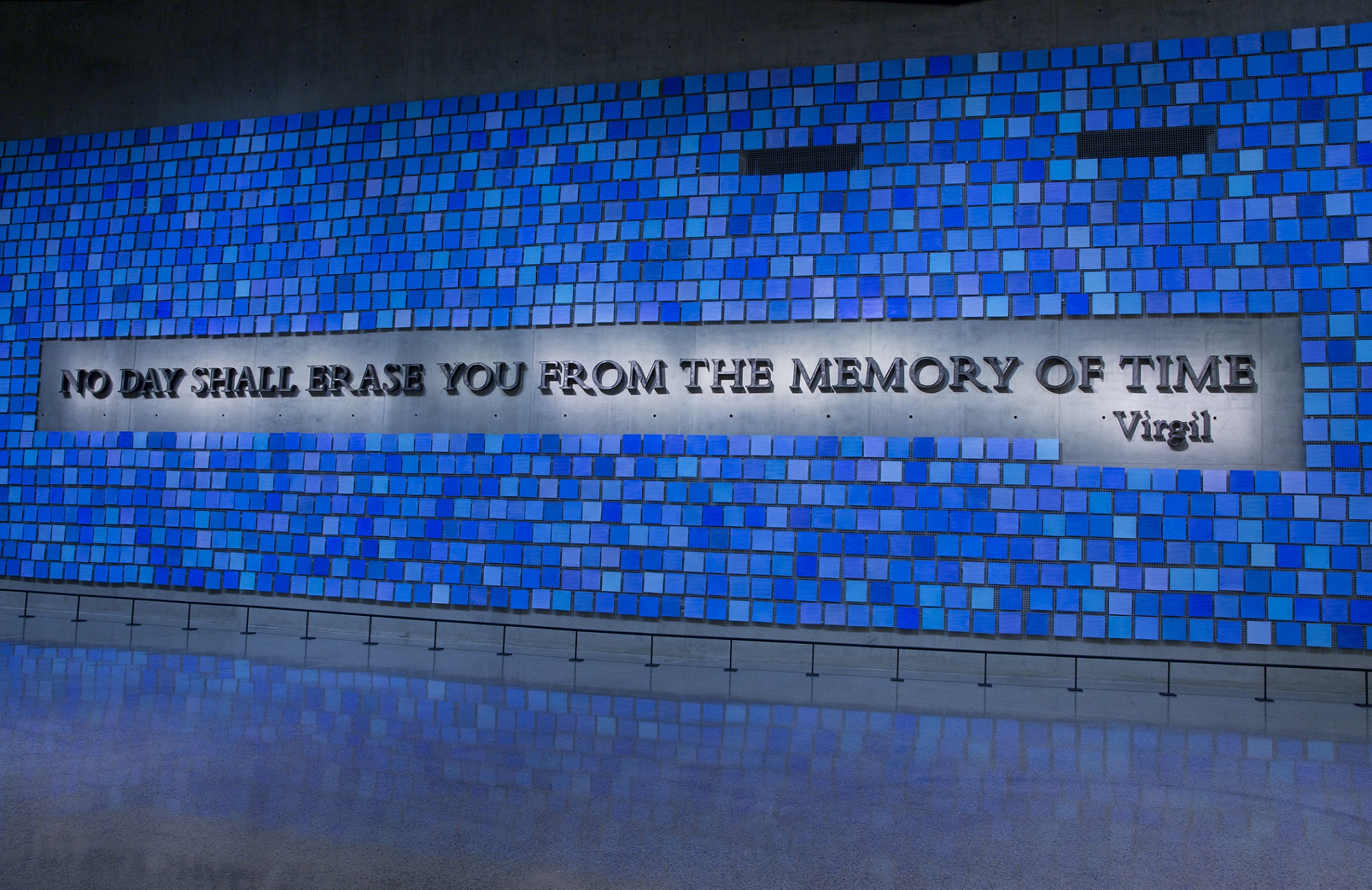 A large plaque in Memorial Hall reads, “No day shall erase you from the memory of time.” The quote from Virgil’s epic poem The Aeneid is surrounded by 2,983 individual blue tiles that comprise "Trying to Remember the Color of the Sky on That September Morning,” an installation by Spencer Finch. Every square is a unique shade of blue, reflecting the artist's attempt to remember the color of the sky on the morning of 9/11 and commemorating the victims of September 11, 2001 and February 26, 1993. 