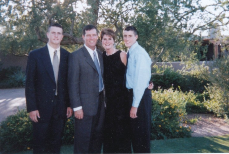 A family of four stands together, two sons, a mom and dad - Kevin, Patrick, James, and Rose
