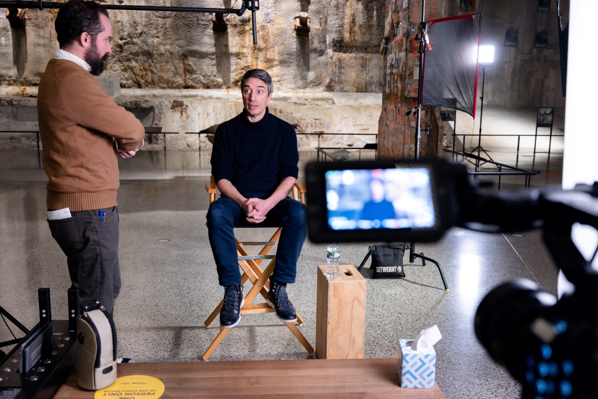 Naudet filming in the Museum, seated in a director's chair