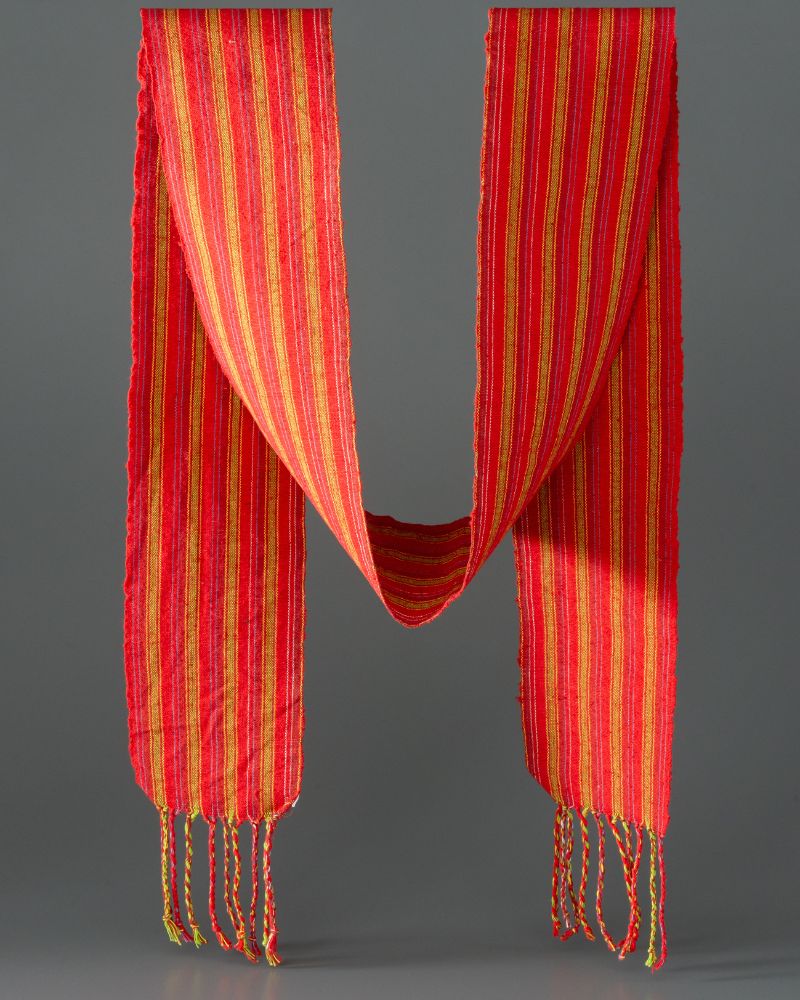 Bold red and yellow stripe sash with tassels at either end.