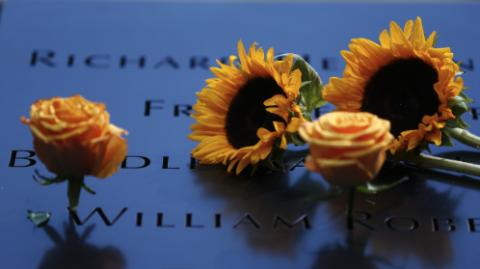 Sunflowers at names on the Memorial