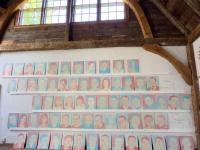 An image of all 67 Portraits hanging together in Katie Ré Scheidt's studio in Roxbury, CT, where they were painted.
