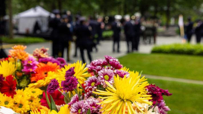 Colorful flowers on a Memorial Glade monolith