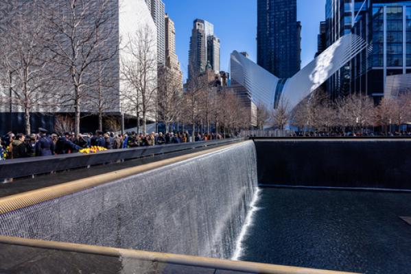 The Memorial pools are shown with water flowing on a sunny day. The Oculus is visible in the background.