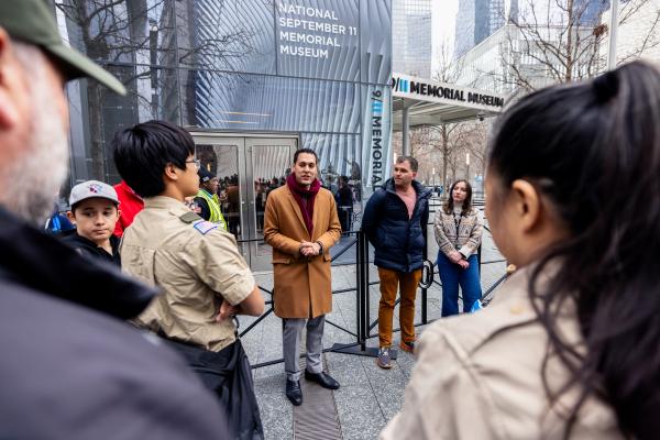 Scouts and a guide stand outside the Museum.