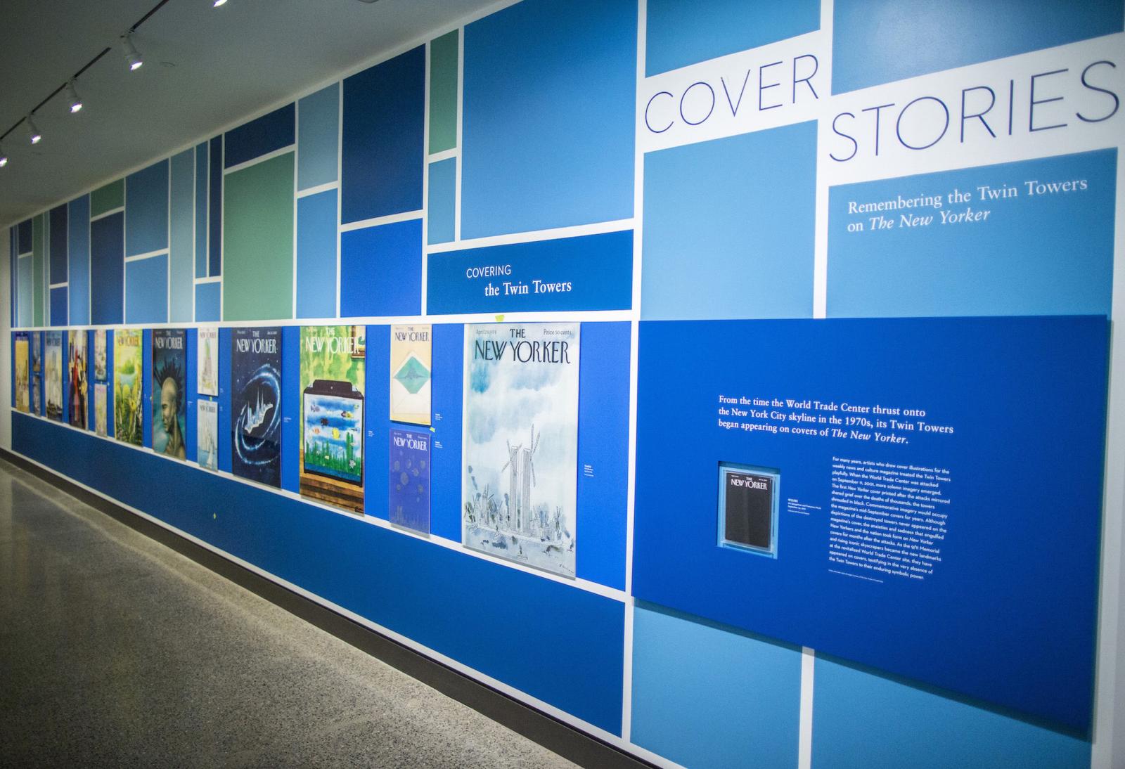 Images of Twin Towers–themed New Yorker covers are displayed on a wall as part of the exhibition Cover Stories.