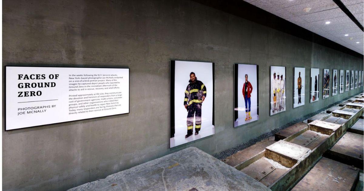 A cement hallway with large photos visible down the wall