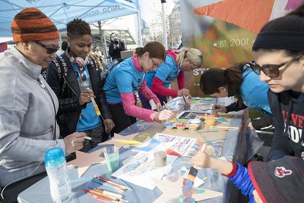 Visitors make artwork during a Community Day on Memorial plaza.