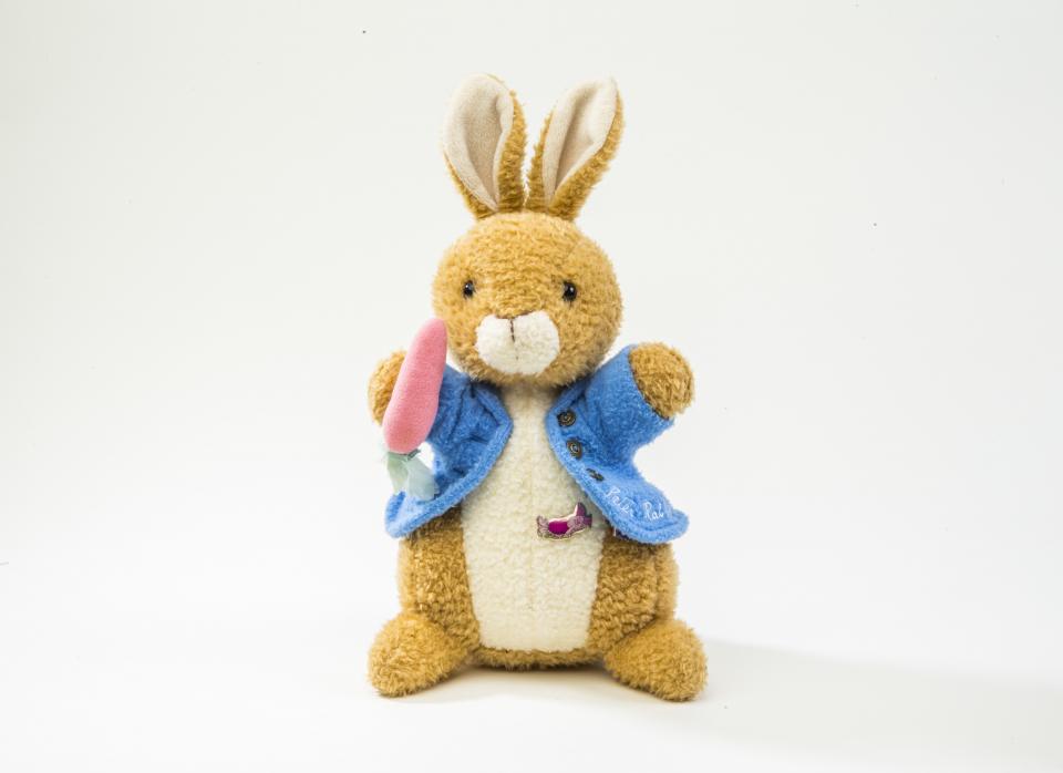 A Peter Rabbit stuffed animal that belonged to the youngest 9/11 victim, Christine Lee Hanson, is displayed on a white surface at the Museum.