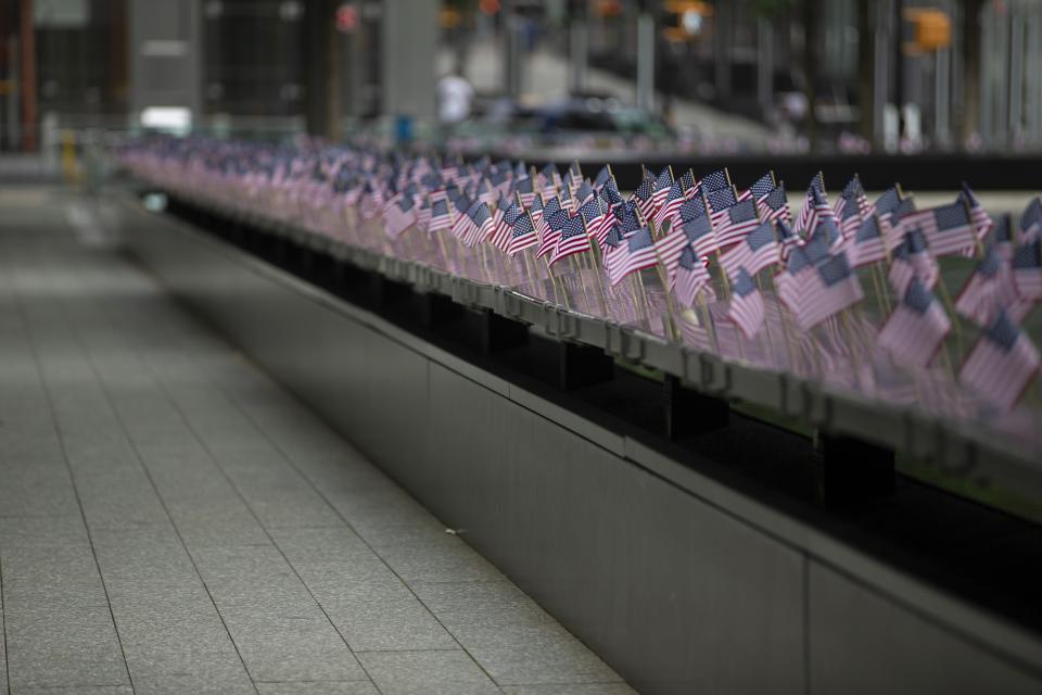 Small American flags line names along the Memorial